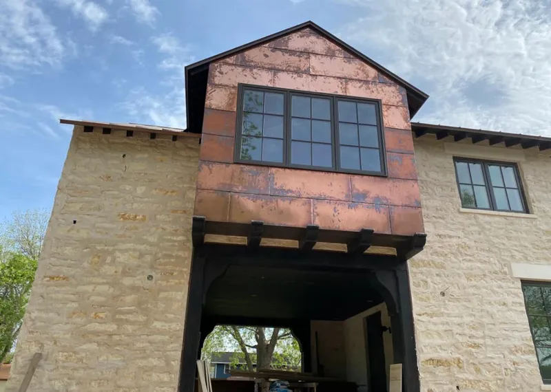 Copper metal panel facade on a stone building for Skylight Installation in Chico